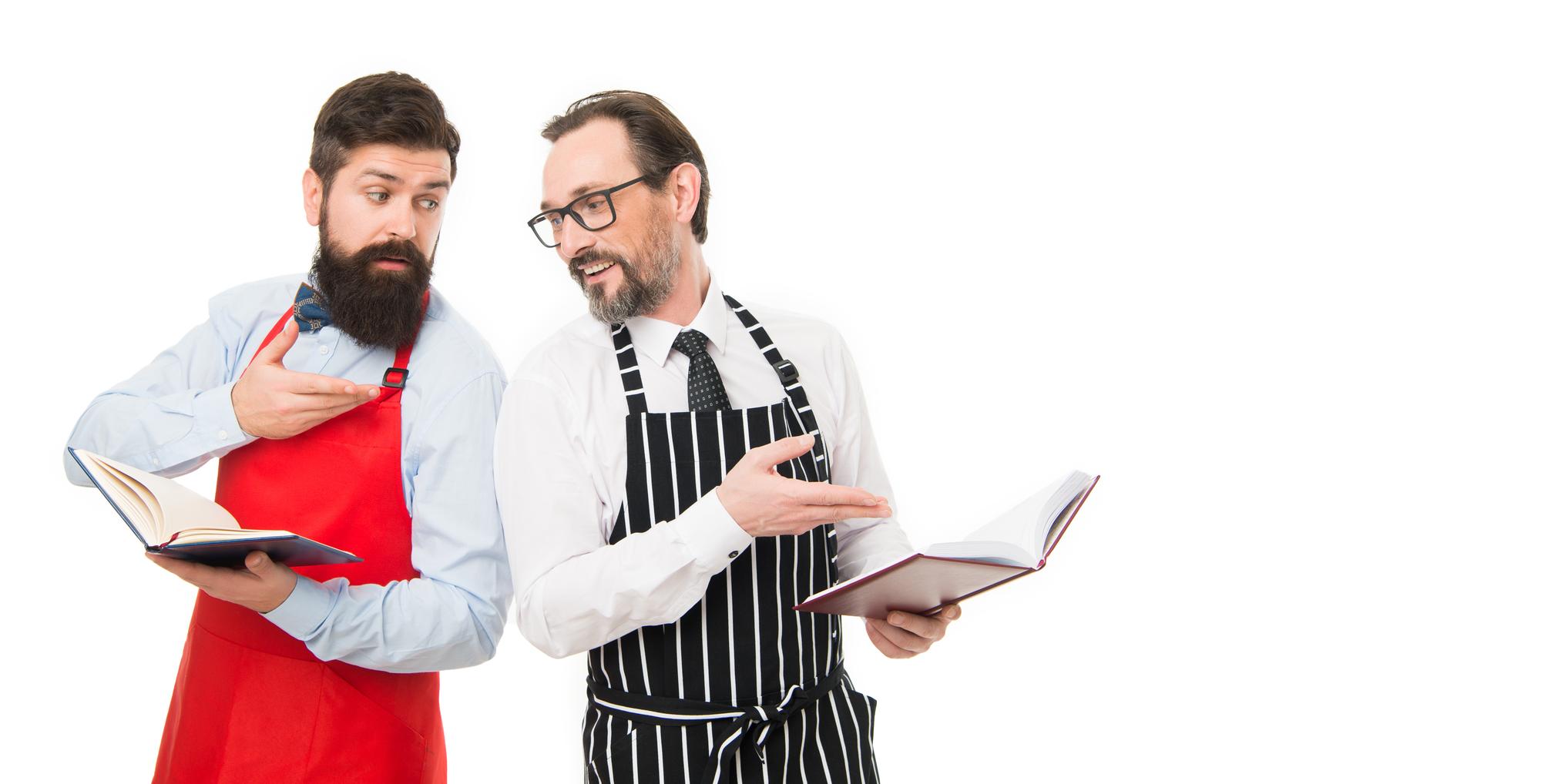 Chef and host discussing menu plans in studio with table of ingredients