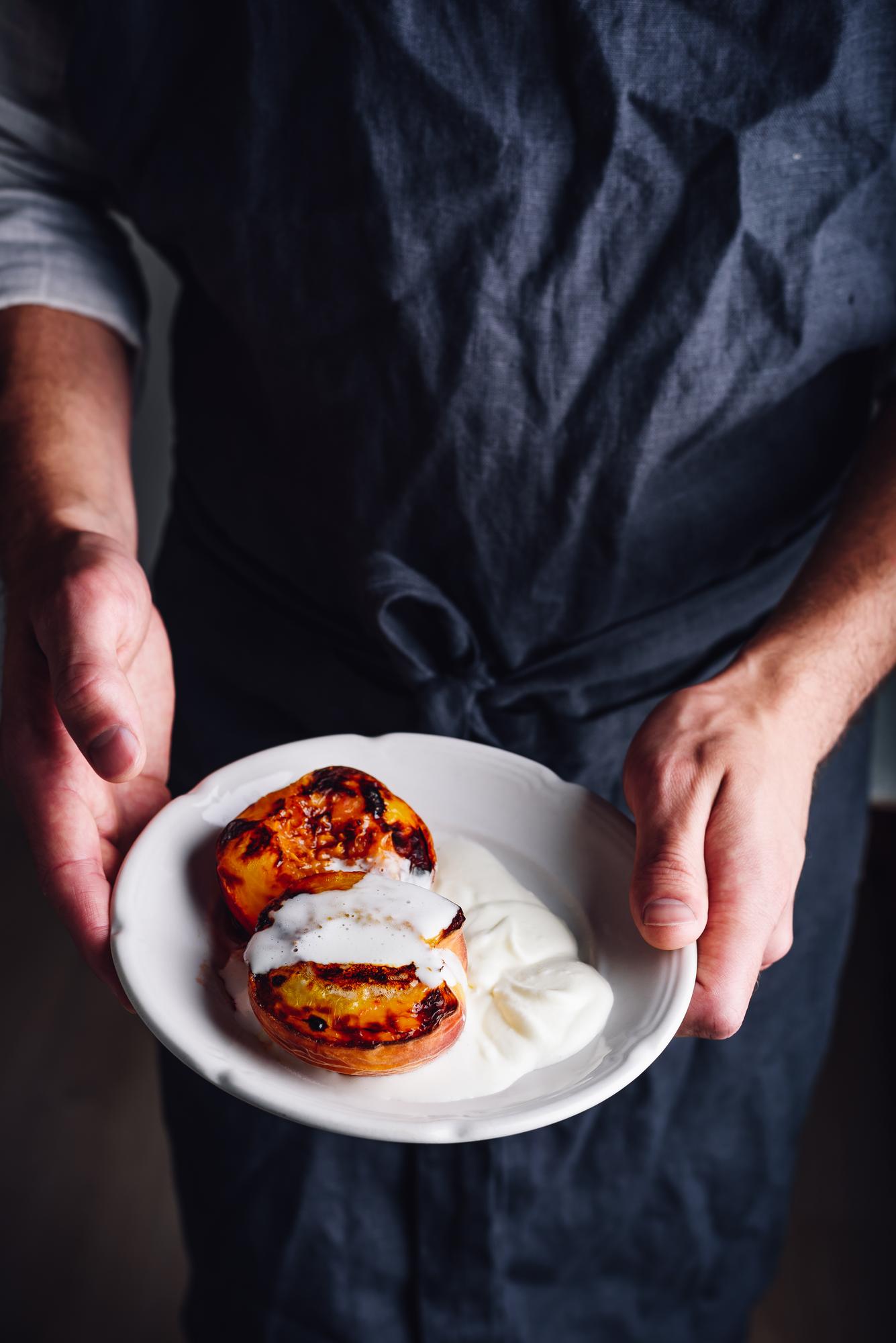 Chef arranging a plated dessert with precision