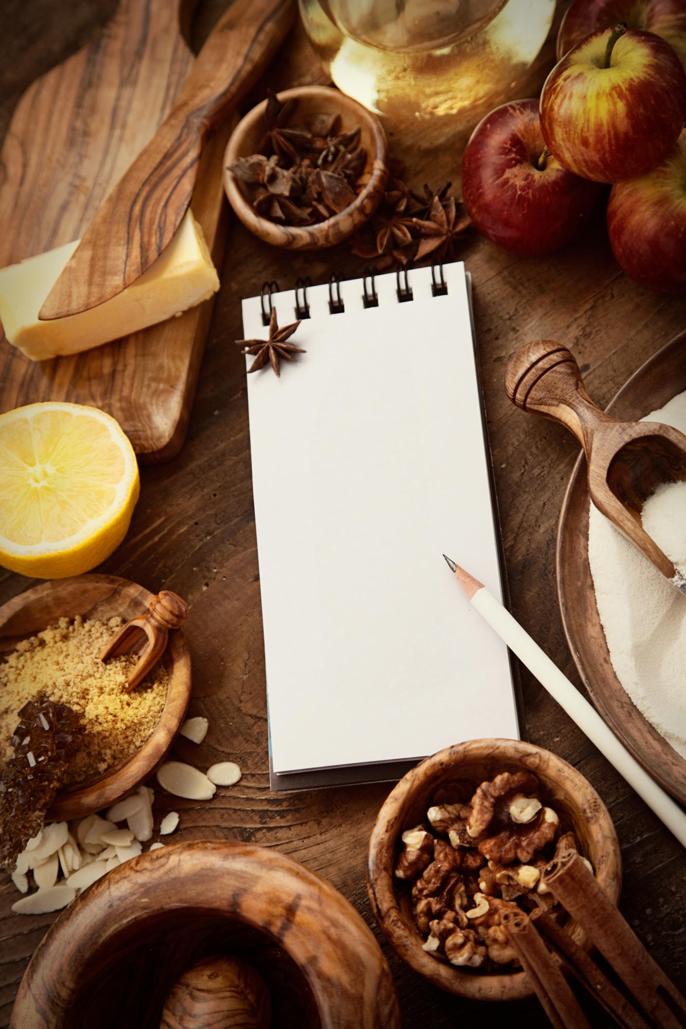 Stack of recipe cards and monthly planner on a wooden table